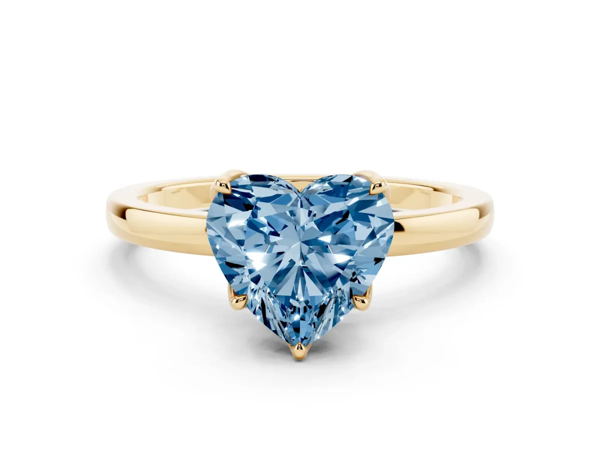 Fancy Blue Heart Cut Diamond Solitaire Ring with Thin Band and Prong Setting Yellow gold