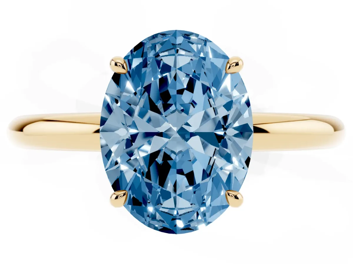 Fancy Blue Oval Cut Diamond Solitaire Ring with Thin Band and Four-Prong Setting Yellow gold