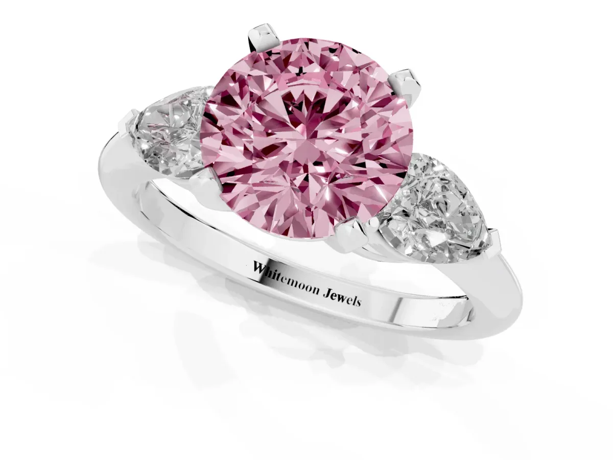 Fancy Pink Three-Stone Round Cut Diamond Ring with Pear Side Stones and Four-Prong Setting Platinum