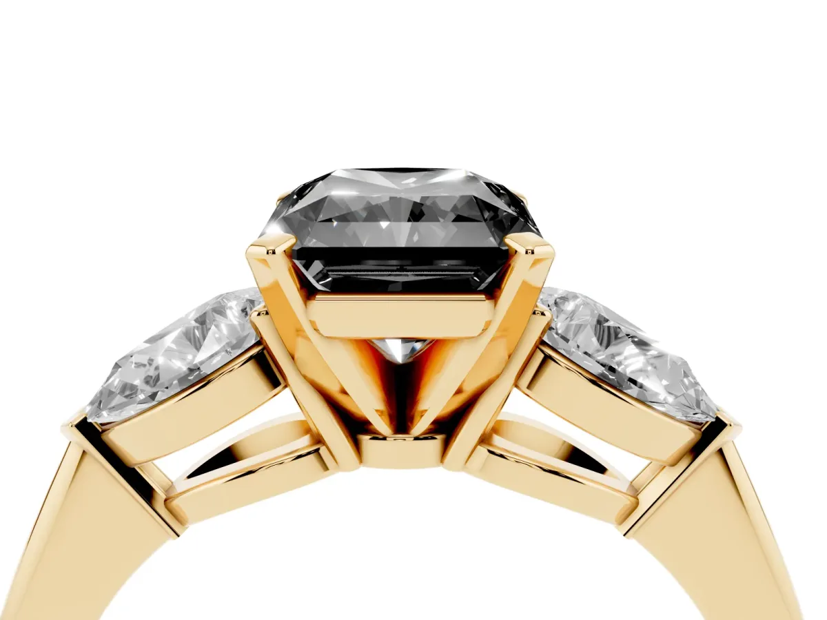 Fancy Black Three-Stone Radiant Cut Diamond Ring with Pear Side Stones and Four-Prong Setting Yellow gold