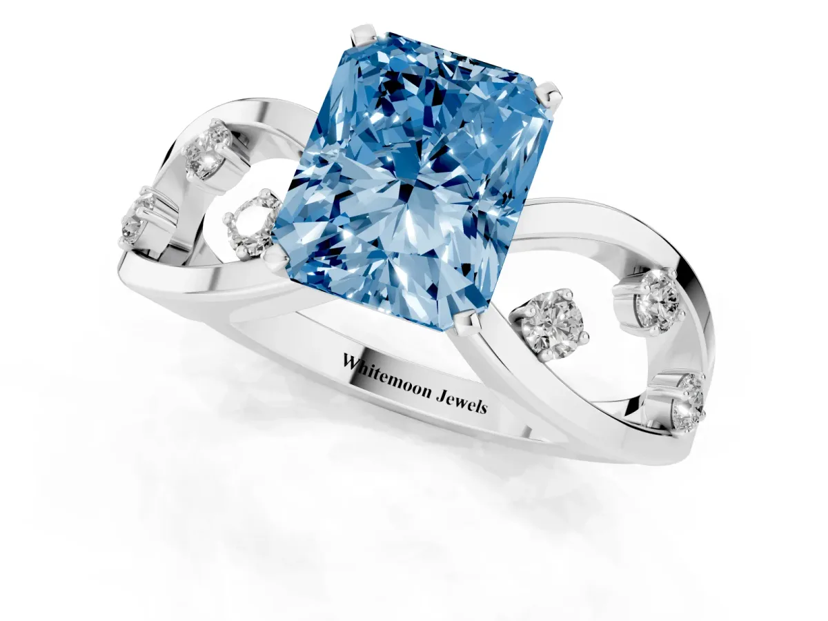 Fancy Blue Radiant Cut Cut Solitaire Diamond with Side Stones on Criss-Cross Band and Four-Prong Setting Platinum