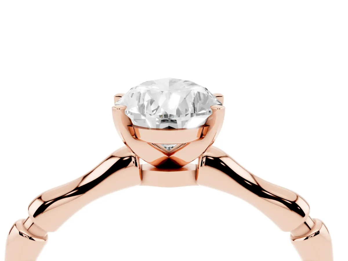 Pear Cut Solitaire Diamond Ring with Bamboo Band and Four-Prong Setting Rose gold