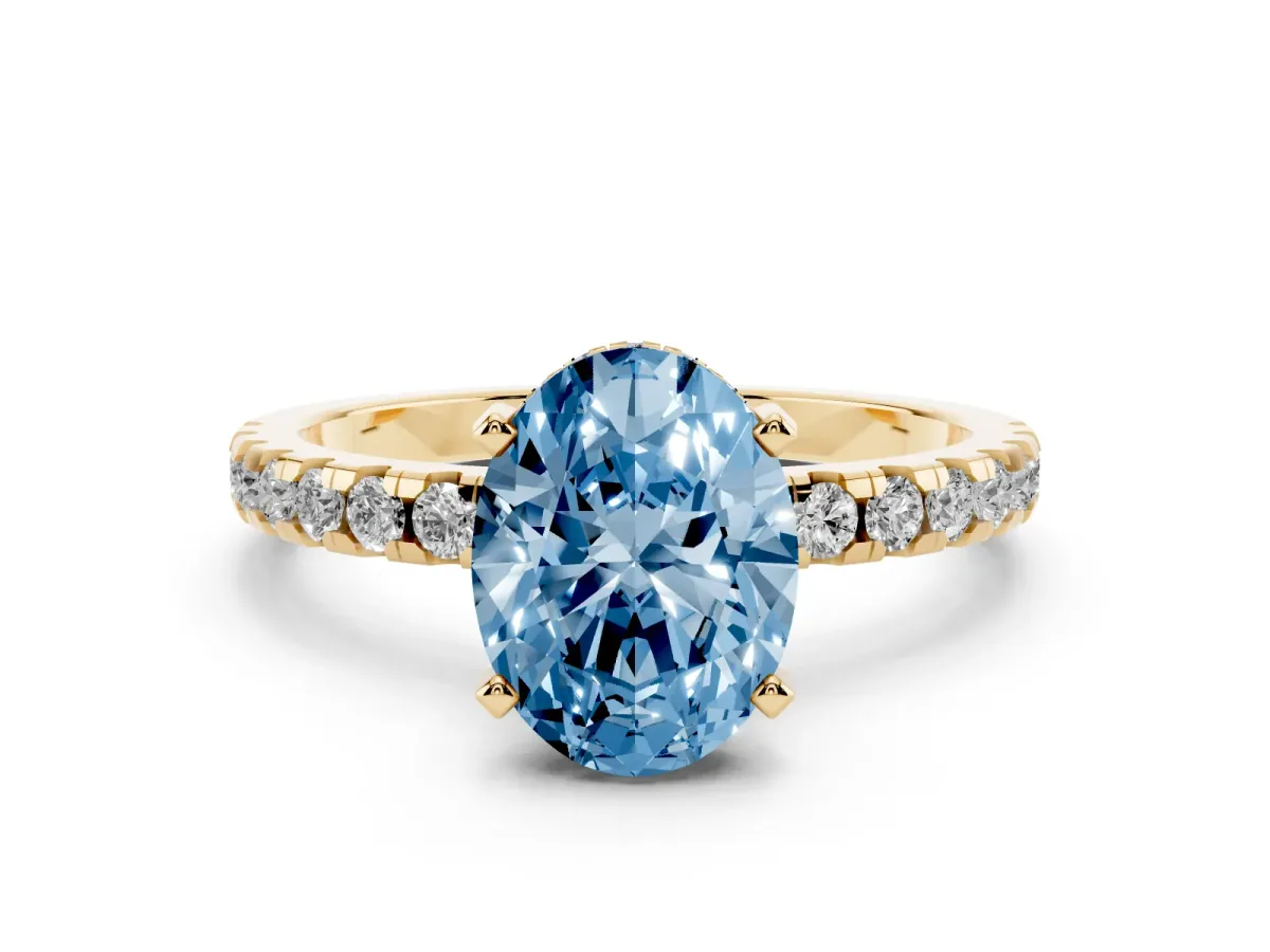 Fancy Blue Oval Cut Diamond Solitaire Ring with Round Pavé Band and Four-Prong Setting Yellow gold