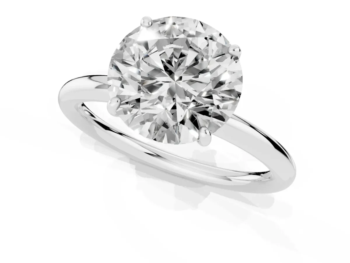 Round Cut Solitaire Diamond Ring with Four-Prong Setting on a Plain Band Platinum