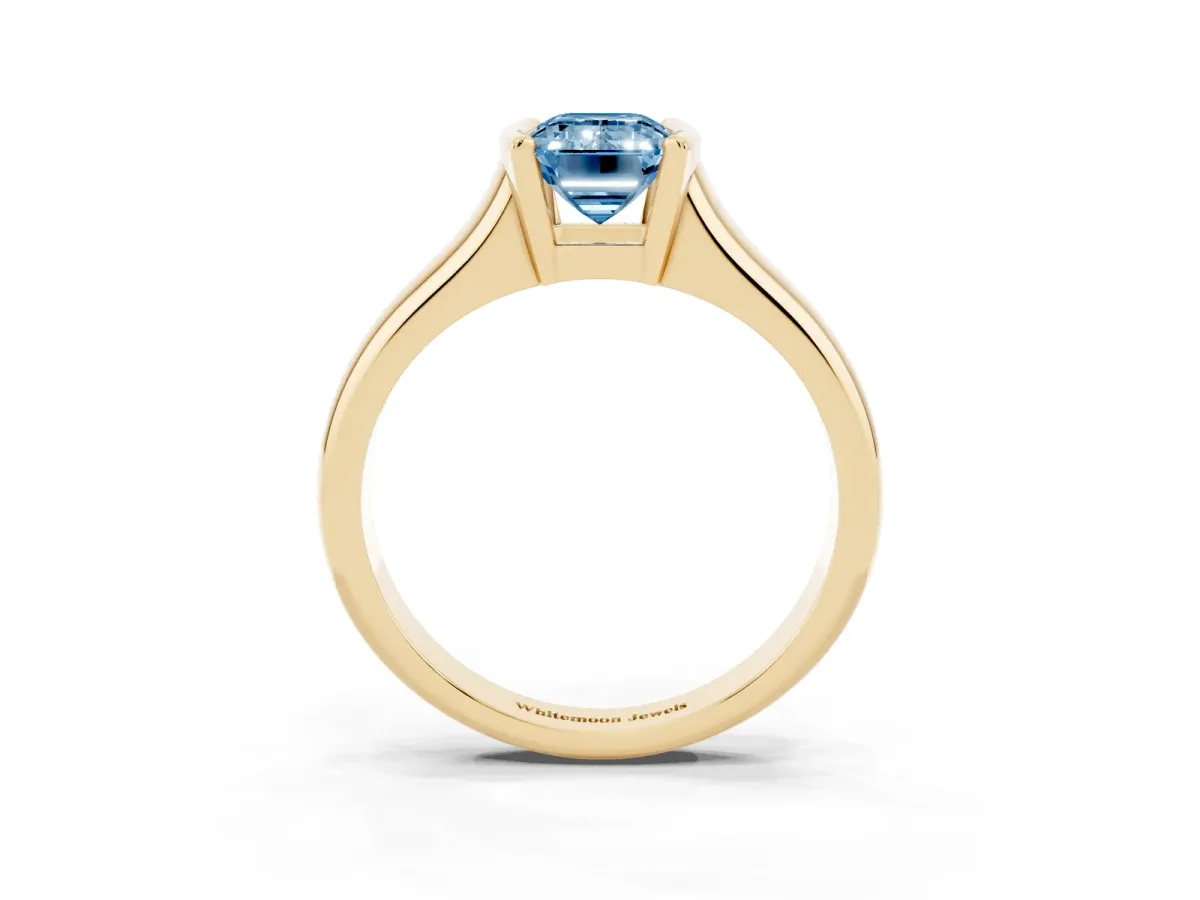 Fancy Blue Emerald Cut Solitaire Tension Set Diamond Ring with Split Shank Band Yellow gold