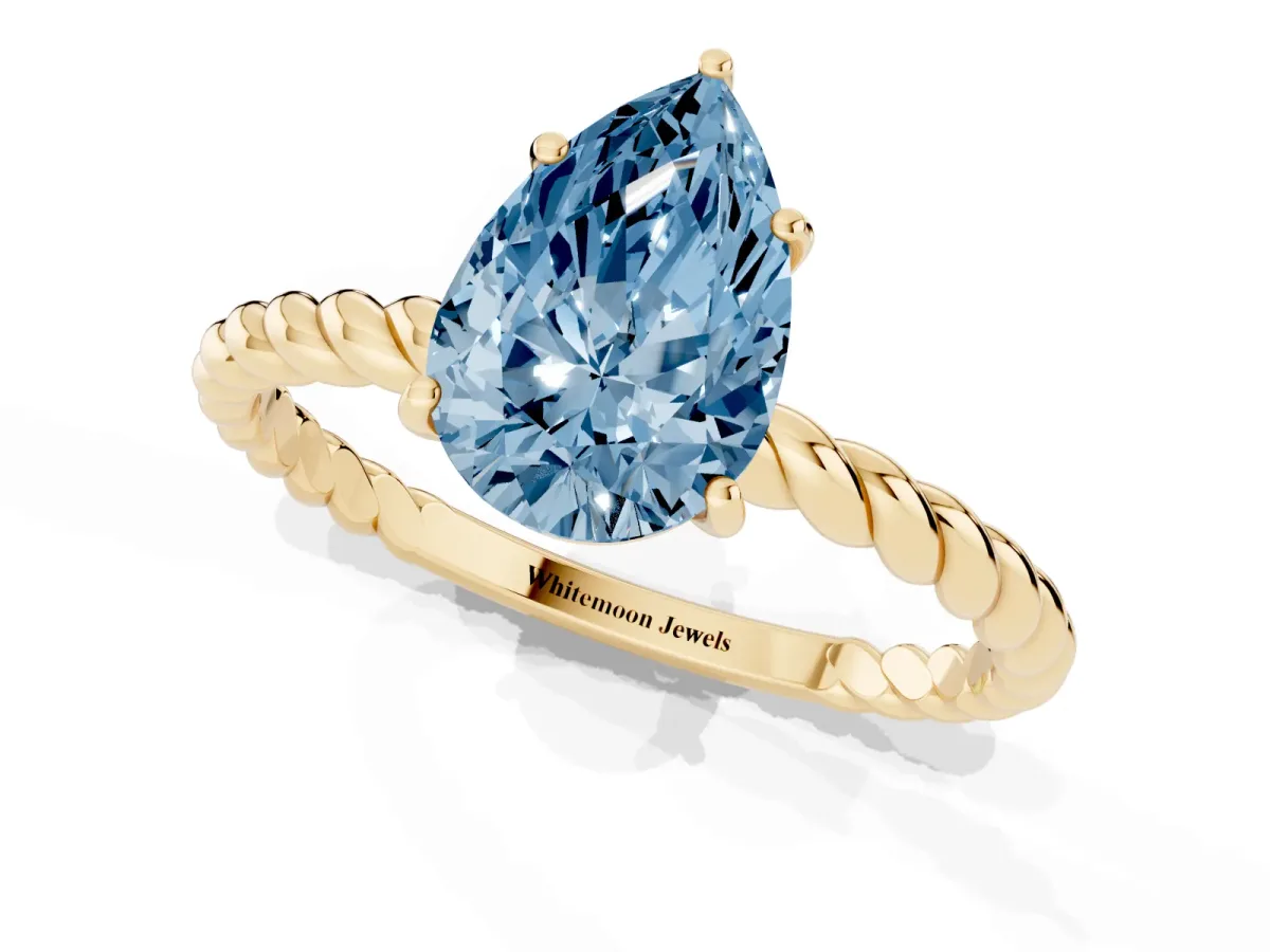 Fancy Blue Pear Cut Solitaire Twist Band Ring with Four-Prong Setting Yellow gold