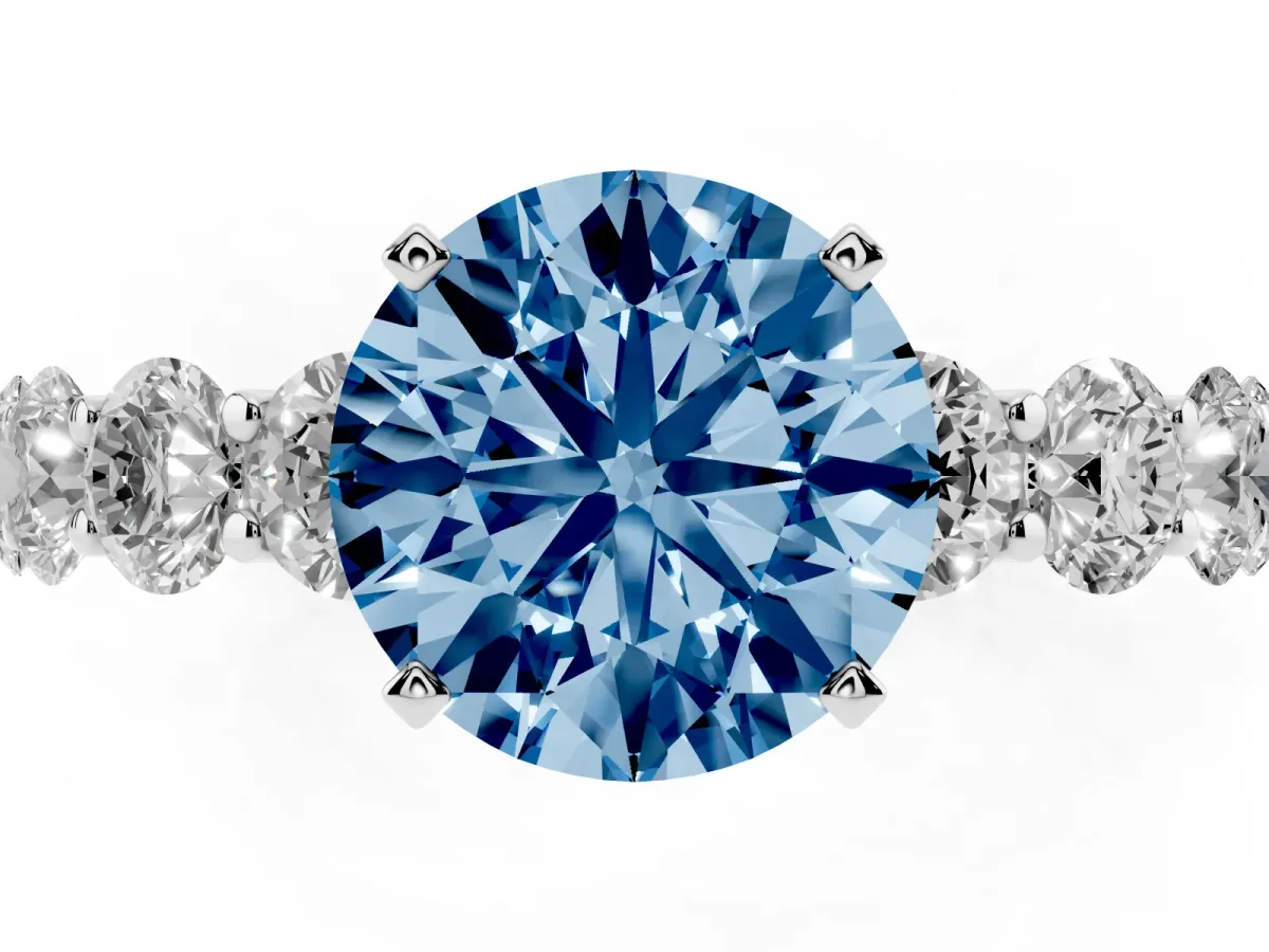 Fancy Blue Round Cut Diamond Prong Setting with Side Stones on a Pave Band Silver