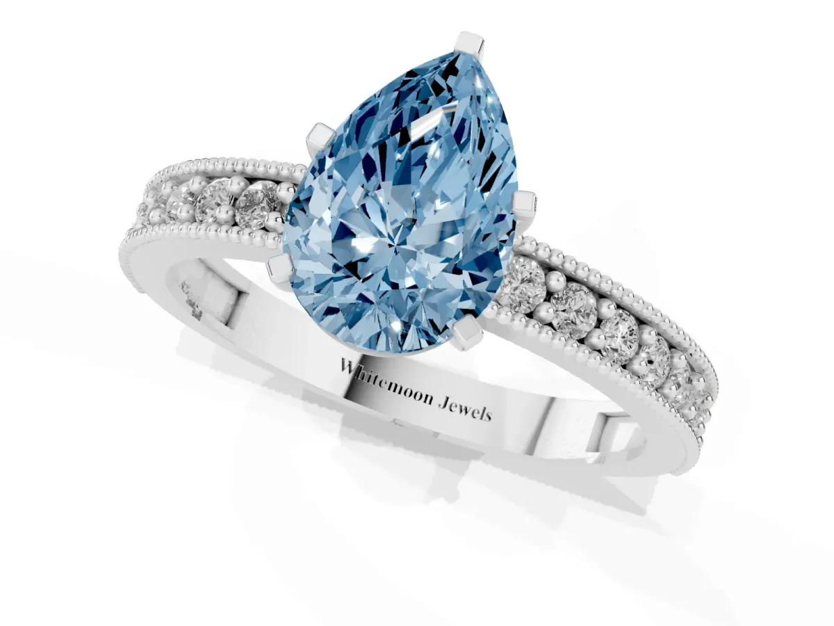 Fancy Blue Pear Cut Diamond Milgrain Pavé Engagement Ring with Four-Prong Setting Platinum