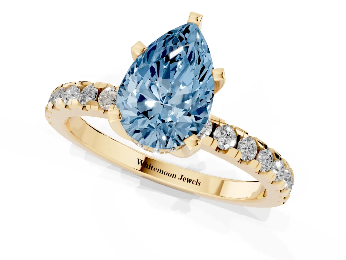 Fancy Blue Pear Cut Diamond Solitaire Ring with Round Pavé Band and Four-Prong Setting Yellow gold