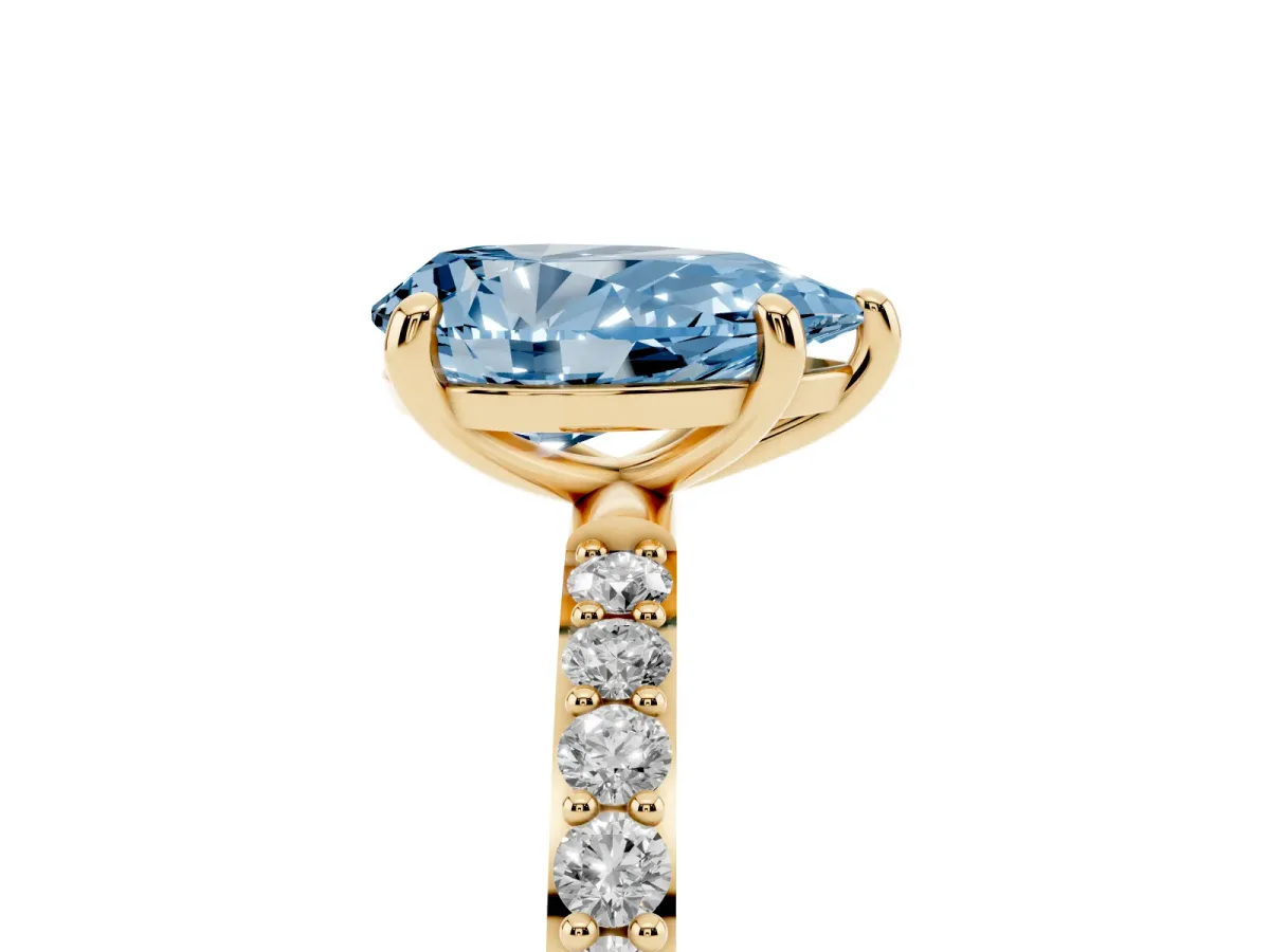 Fancy Blue Pear Cut Diamond Solitaire Ring with Round Pavé Band and Prong Setting Yellow gold
