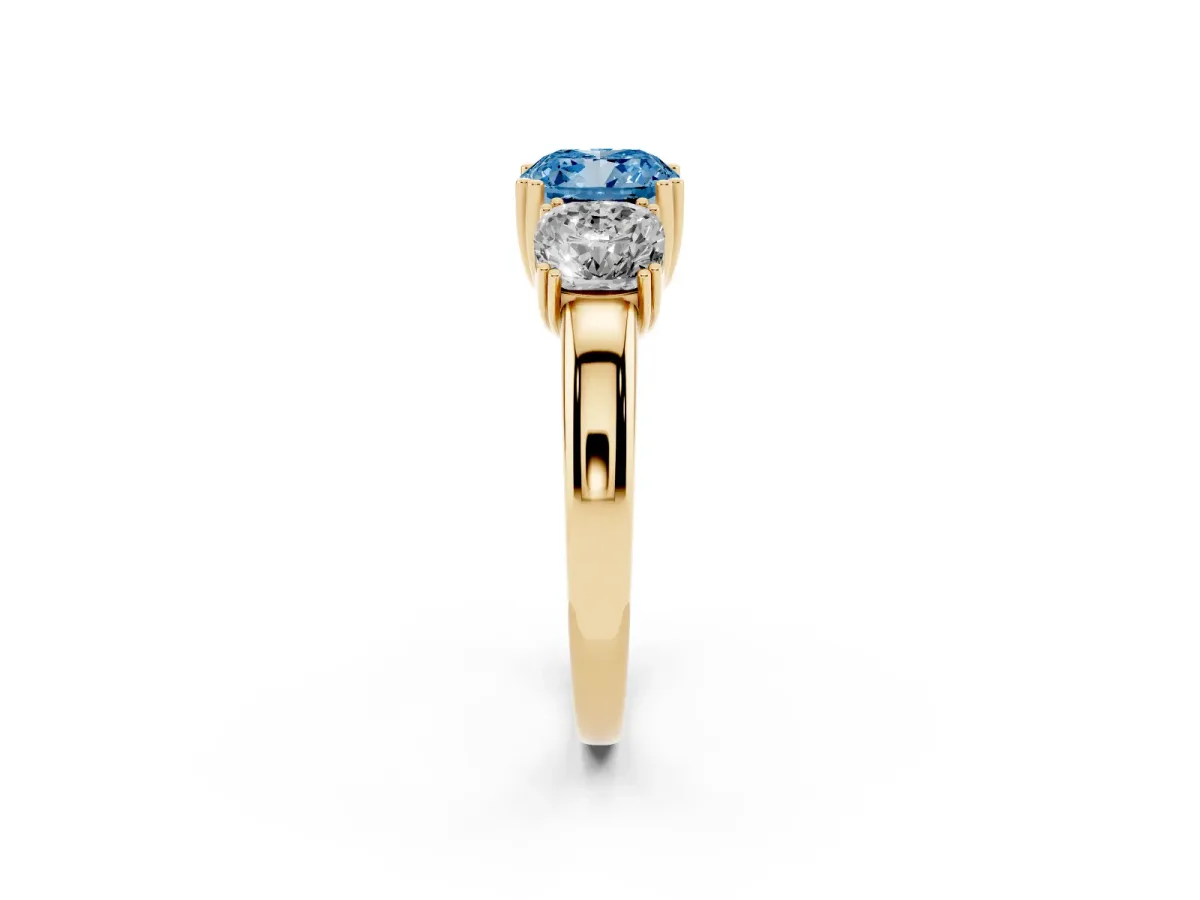 Fancy Blue Three-Stone Cushion Cut Cut Diamond Ring with Channel Set Band and Four-Prong Setting Yellow gold