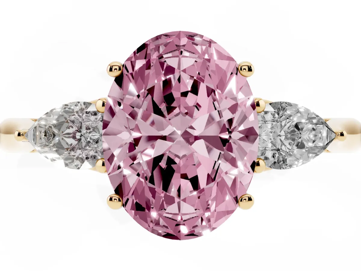 Fancy Pink Three-Stone Oval Cut Brilliant Diamond Solitaire Ring with Tapered Band and Four-Prong Setting Yellow gold