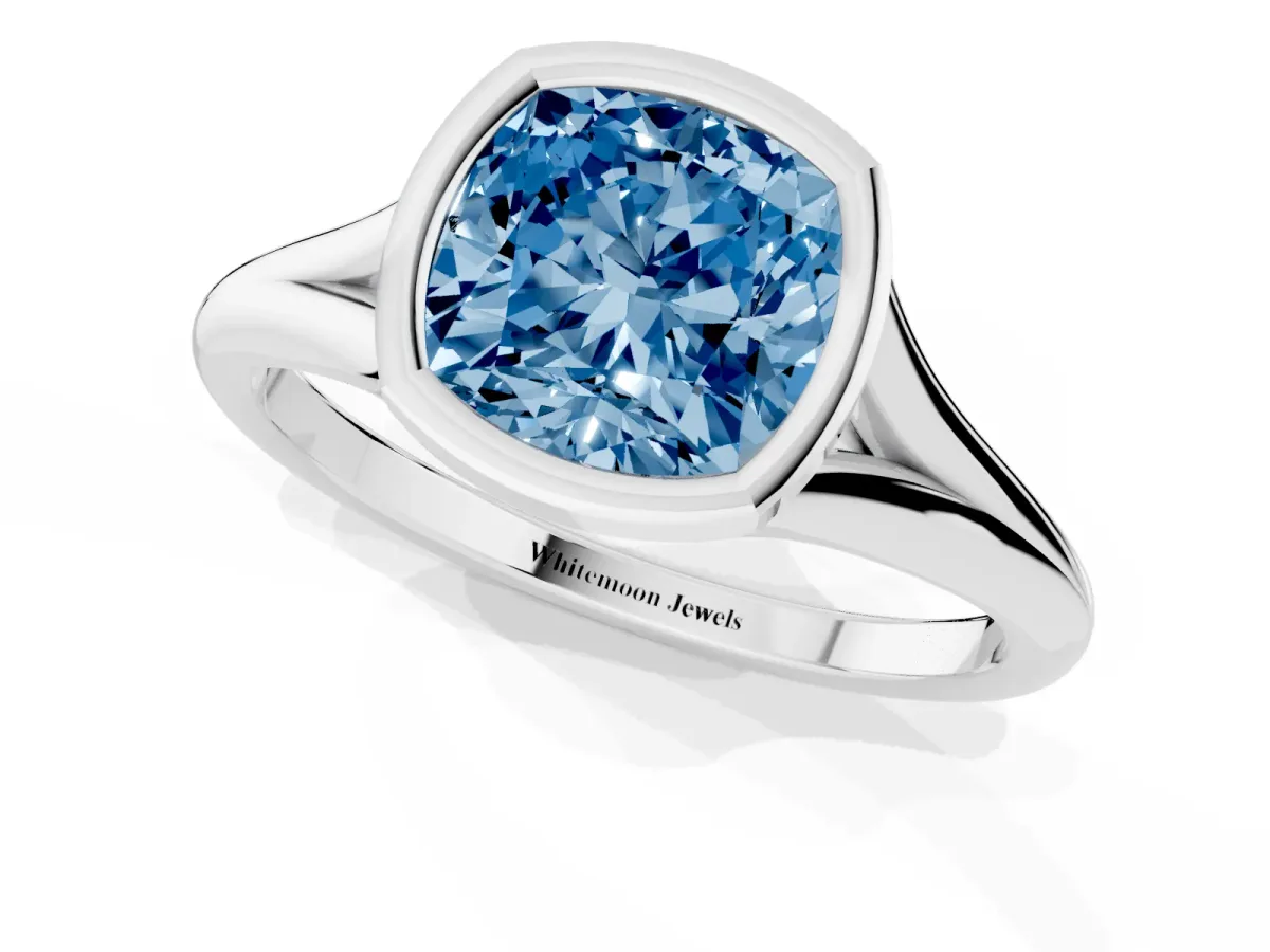 Fancy Blue Bezel Set Cushion Cut Cut Solitaire Ring with Tapered Band Silver