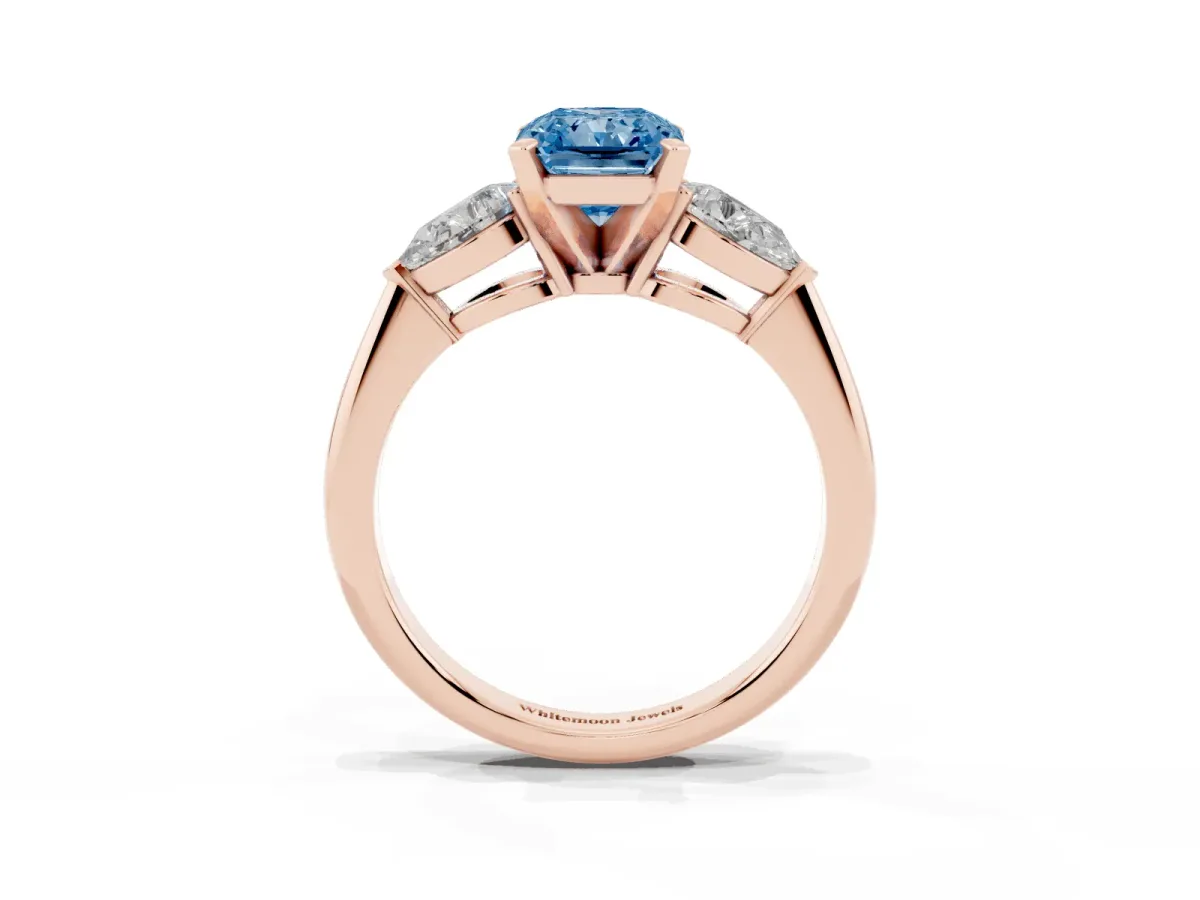 Fancy Blue Three-Stone Radiant Cut Diamond Ring with Pear Side Stones and Four-Prong Setting Rose gold