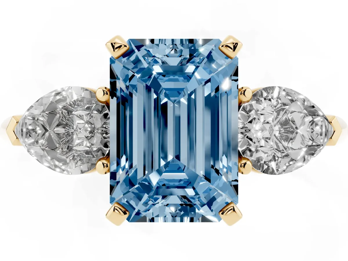 Fancy Blue Three-Stone Emerald Cut Diamond Ring with Pear Side Stones and Four-Prong Setting Yellow gold