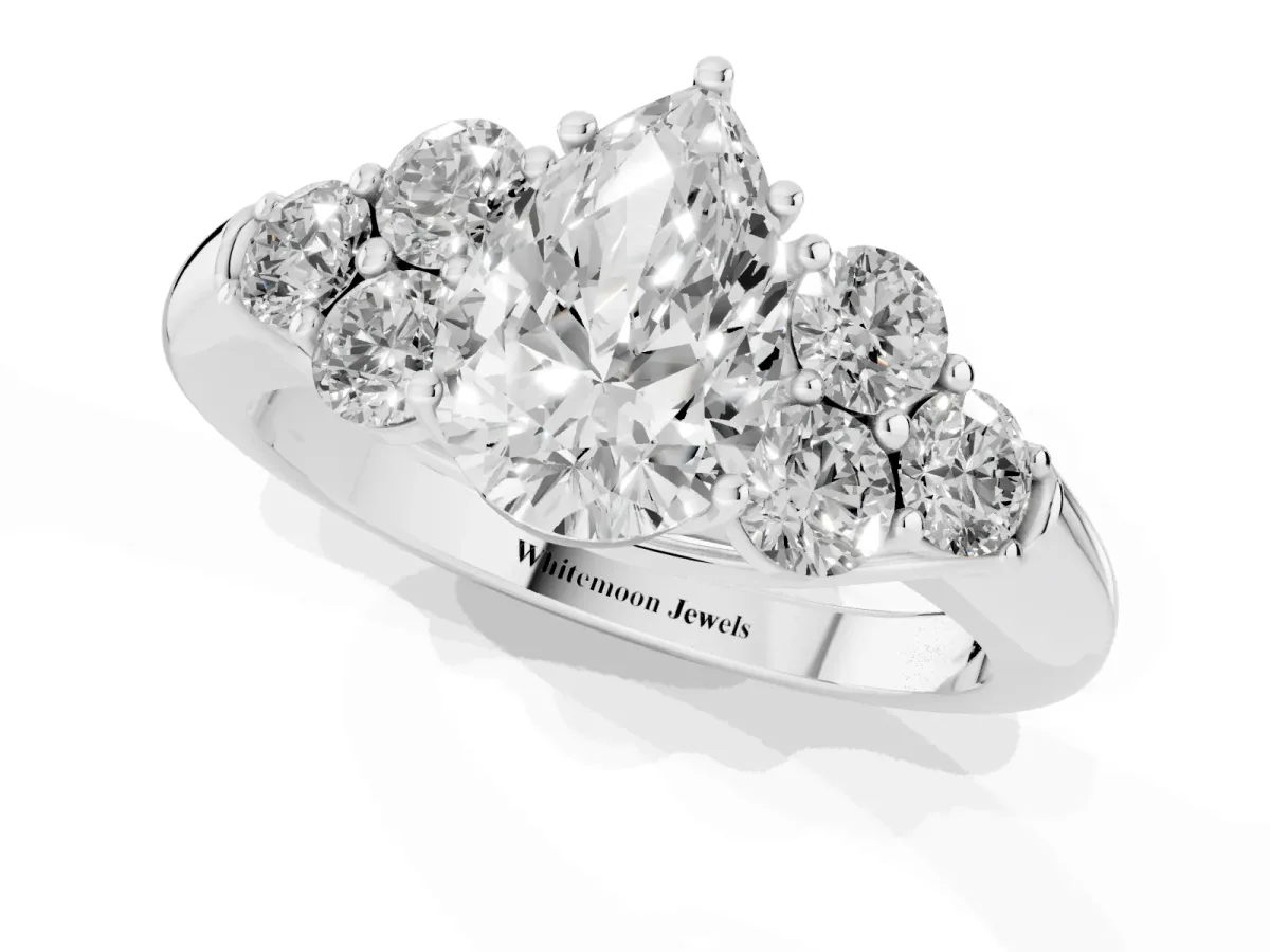 Pear Cut Cut Diamond Cluster Ring with Round Accent Stones and Prong Setting on a Classic Band White gold