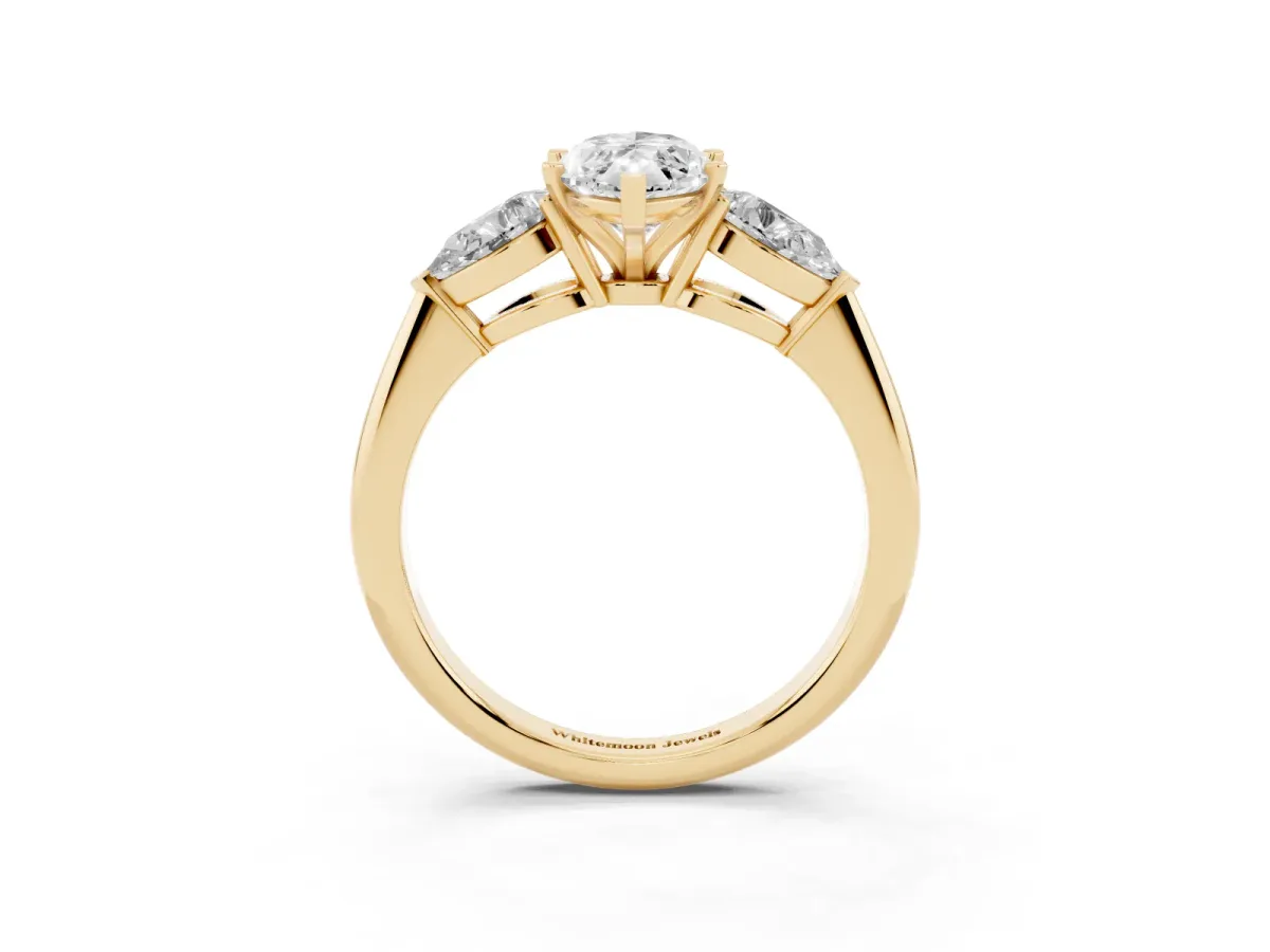 Three-Stone Marquise Cut Diamond Ring with Pear Side Stones and Four-Prong Setting Yellow gold
