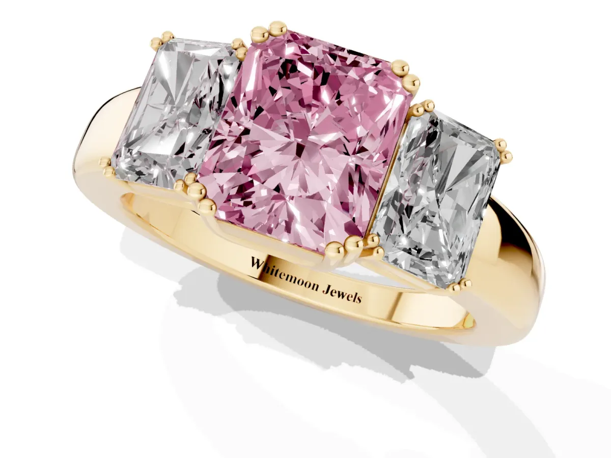 Fancy Pink Three-Stone Radiant Cut Cut Diamond Ring with Channel Set Band and Four-Prong Setting Yellow gold