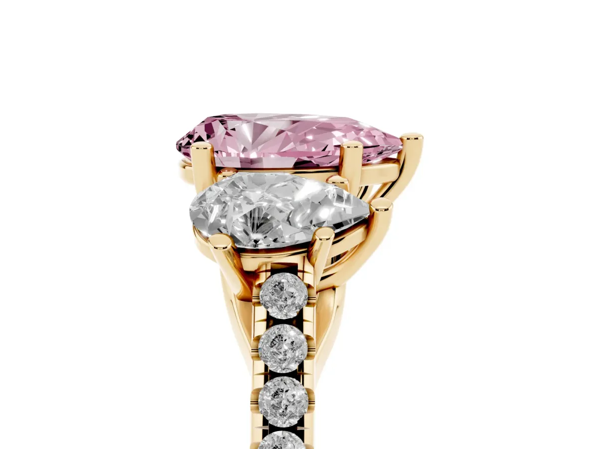 Fancy Pink Three-Stone Pear Cut Diamond Ring with Round Pavé Band and Prong Setting Yellow gold