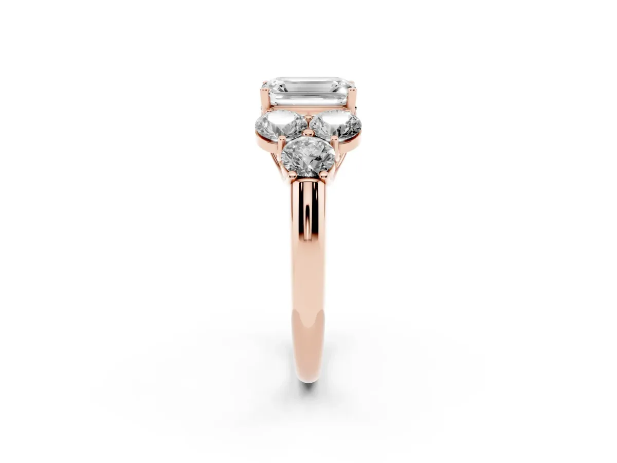 Emerald Cut Cut Diamond Cluster Ring with Round Accent Stones and Prong Setting on a Classic Band Rose gold