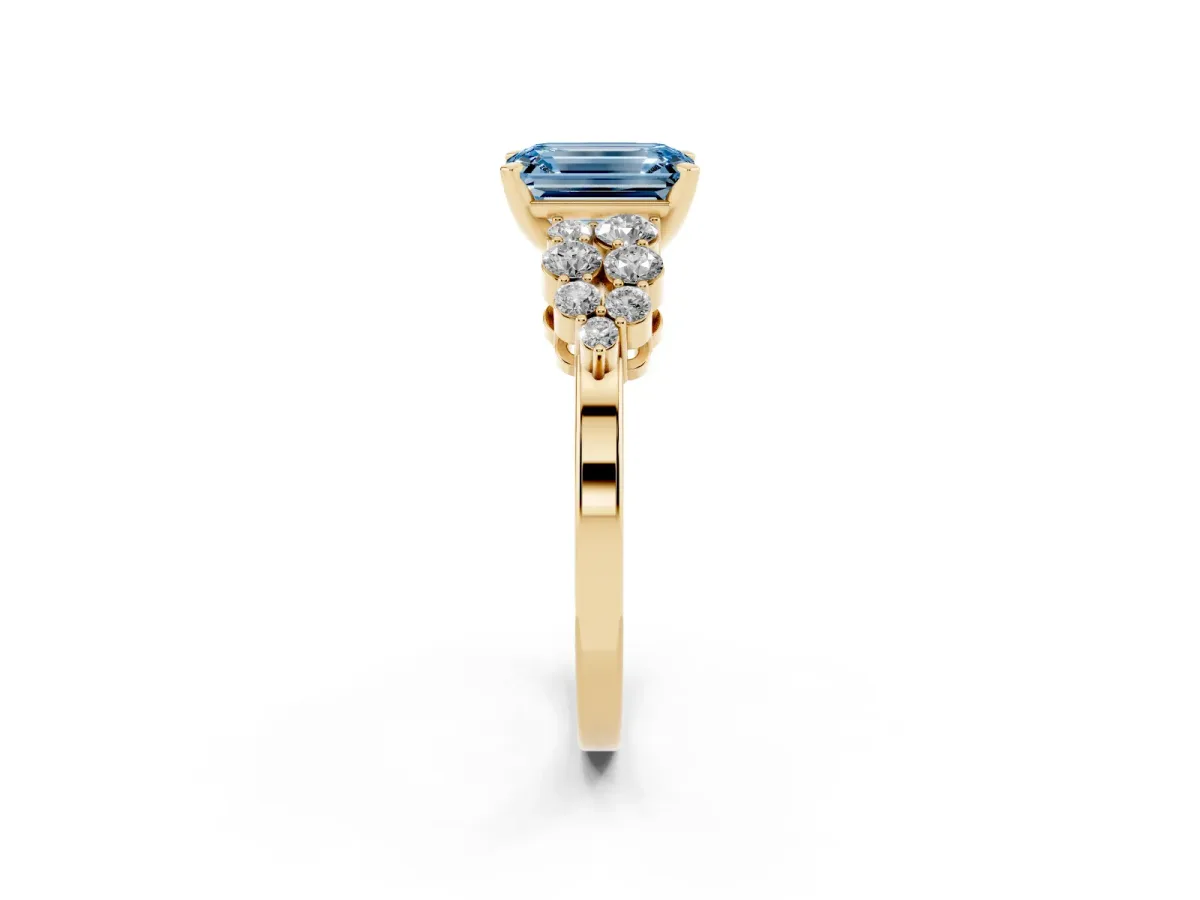Fancy Blue Emerald Cut Cluster Diamond Engagement Ring with Pavé Band and Four-Prong Setting Yellow gold