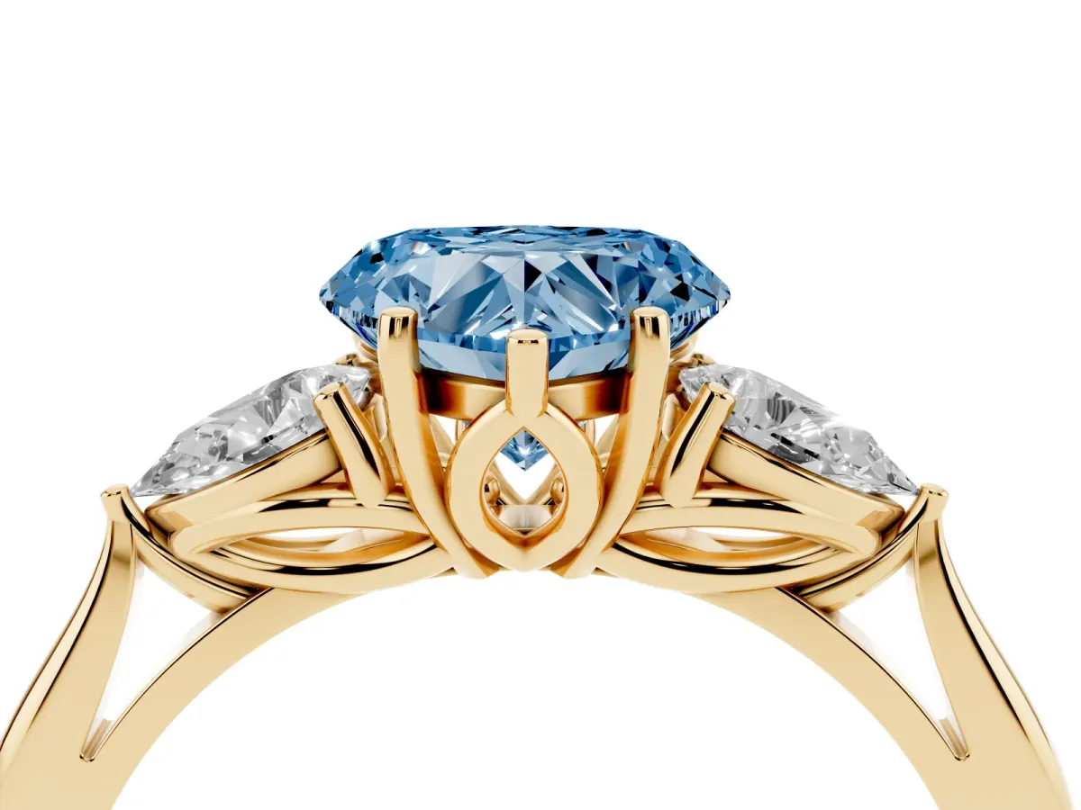 Fancy Blue Three-Stone Heart Cut Brilliant Diamond Solitaire Ring with Tapered Band and Four-Prong Setting Yellow gold