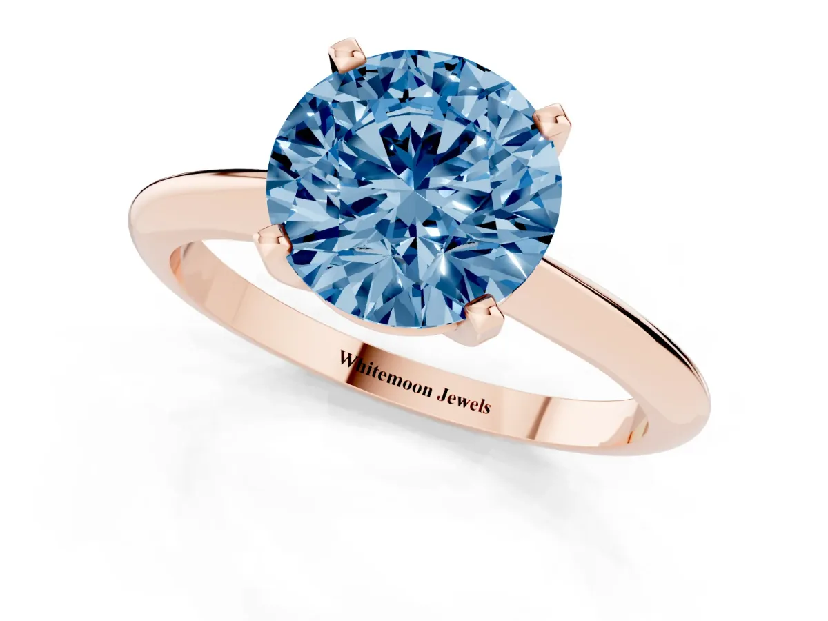 Fancy Blue Round Cut Cut Solitaire Ring with Four-Prong Setting on a Classic Band Rose gold