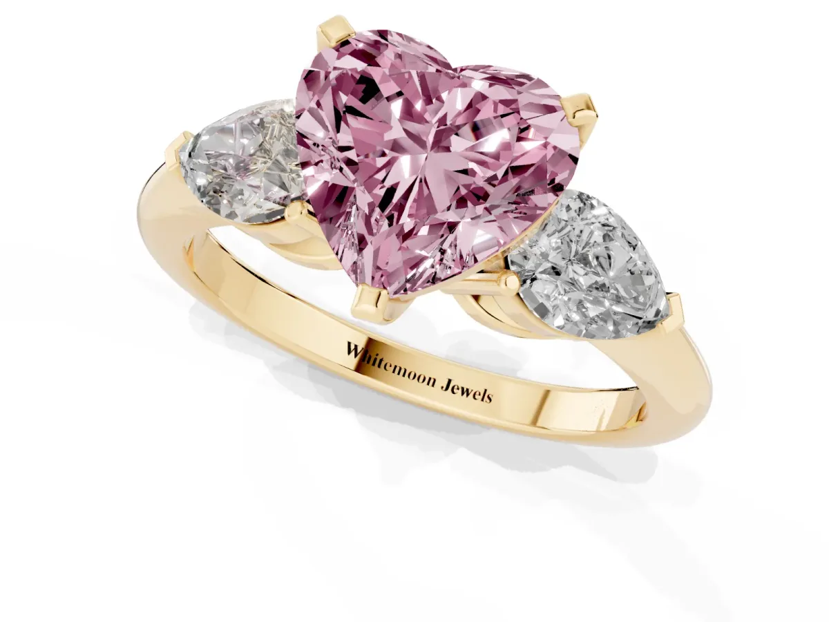 Fancy Pink Three-Stone Heart Cut Diamond Ring with Pear Side Stones and Four-Prong Setting Yellow gold