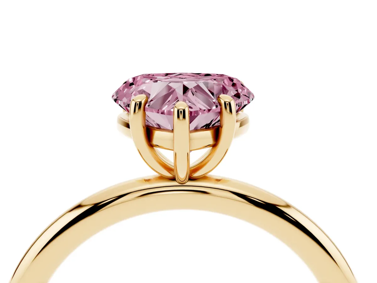 Fancy Pink Heart Cut Solitaire Diamond Ring with Four-Prong Setting on a Plain Band Yellow gold