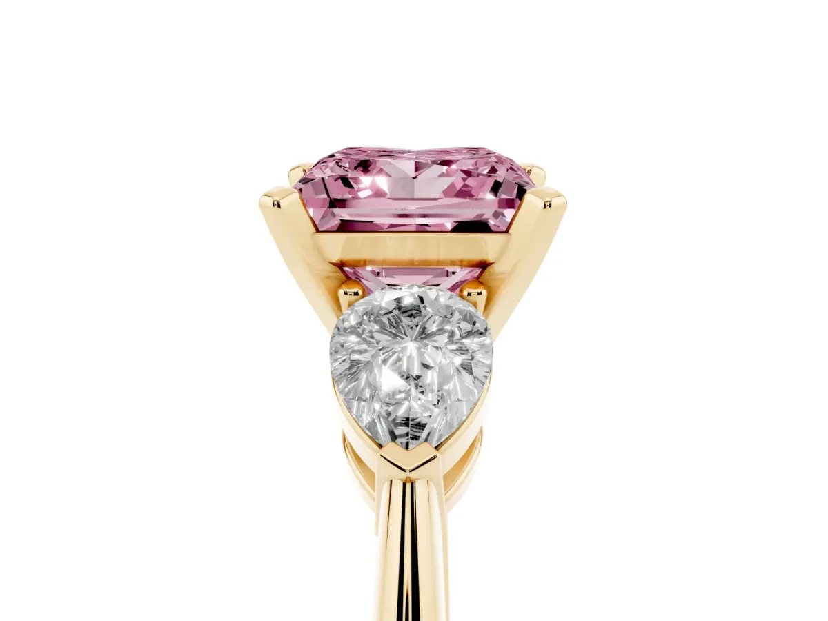 Fancy Pink Three-Stone Princess Cut Diamond Ring with Pear Side Stones and Four-Prong Setting Yellow gold
