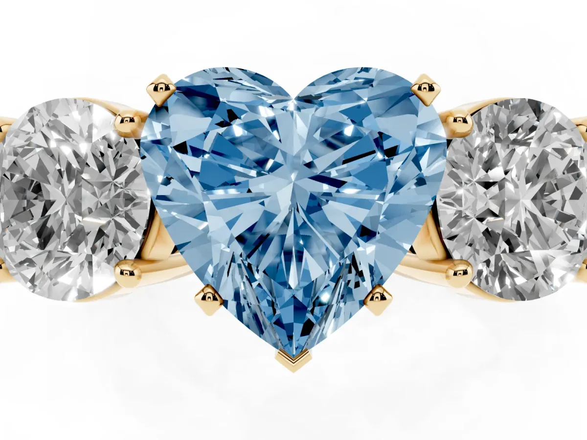 Fancy Blue Three-Stone Heart Cut Diamond Ring with Round Side Stones, Classic Band, and Four-Prong Setting Yellow gold