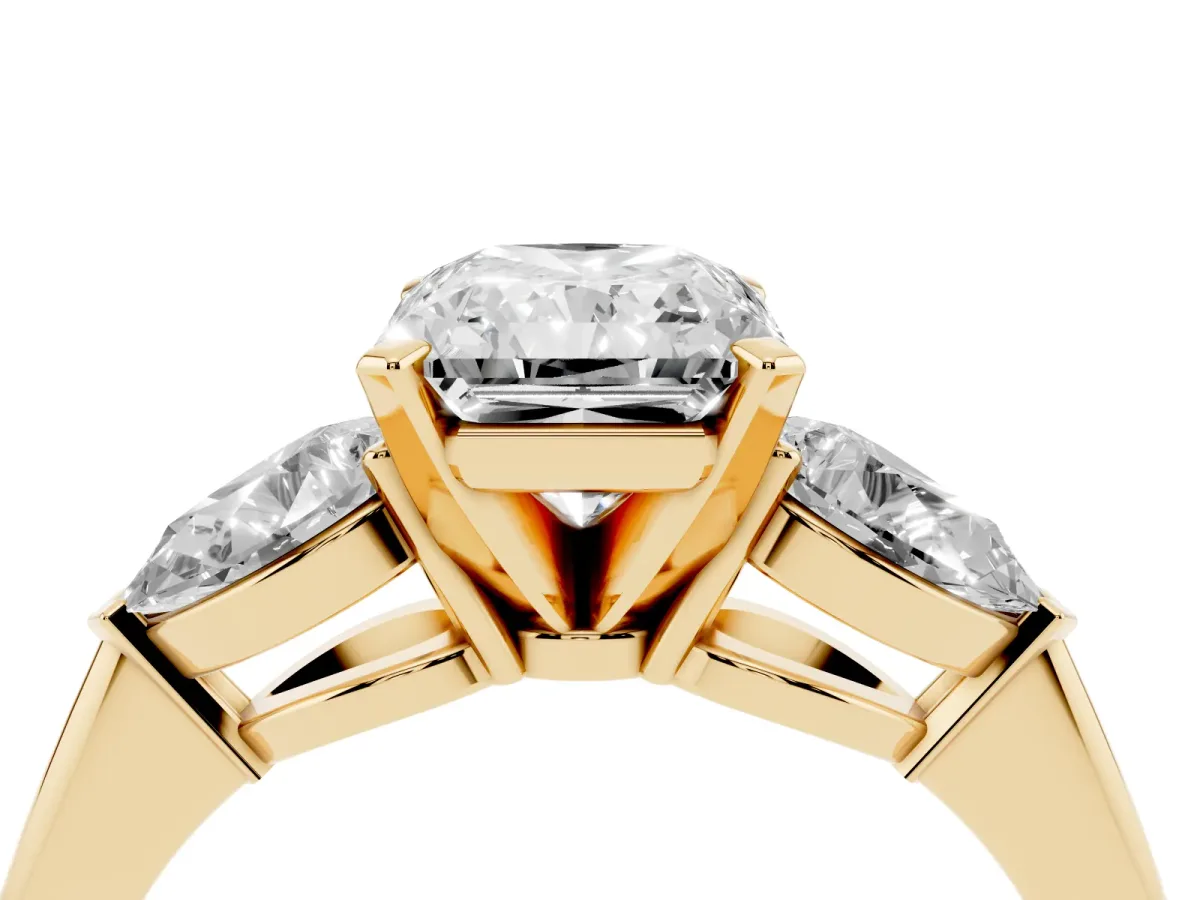 Three-Stone Radiant Cut Diamond Ring with Pear Side Stones and Four-Prong Setting Yellow gold