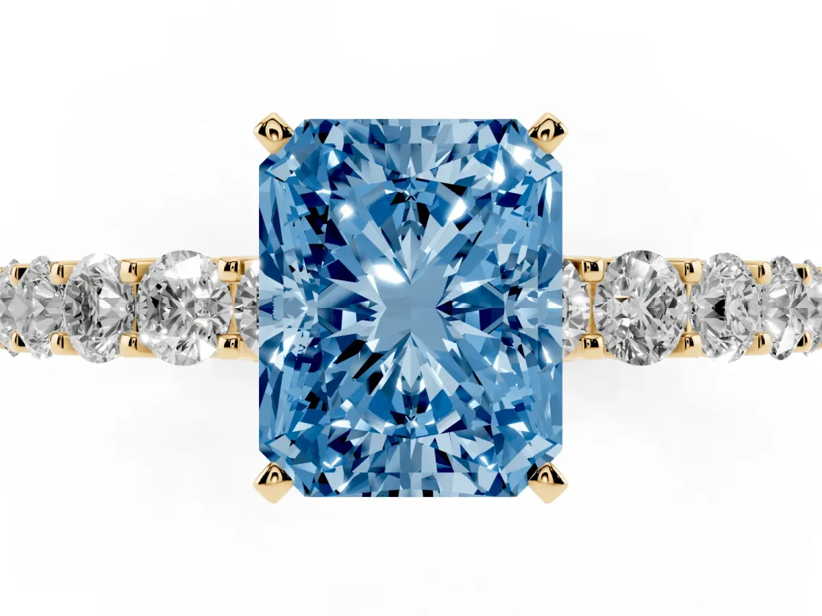 Fancy Blue Radiant Cut Diamond Solitaire Ring with Shared Prong Pavé Band and Four-Prong Setting Yellow gold