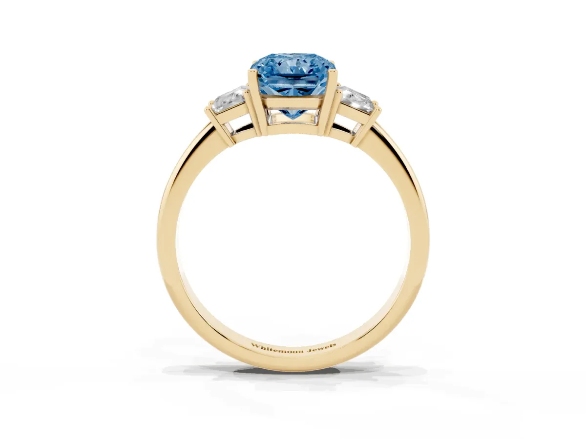 Fancy Blue Radiant Cut Diamond Three-Stone Ring with Trapezoid Side Stones and Prong Setting Yellow gold