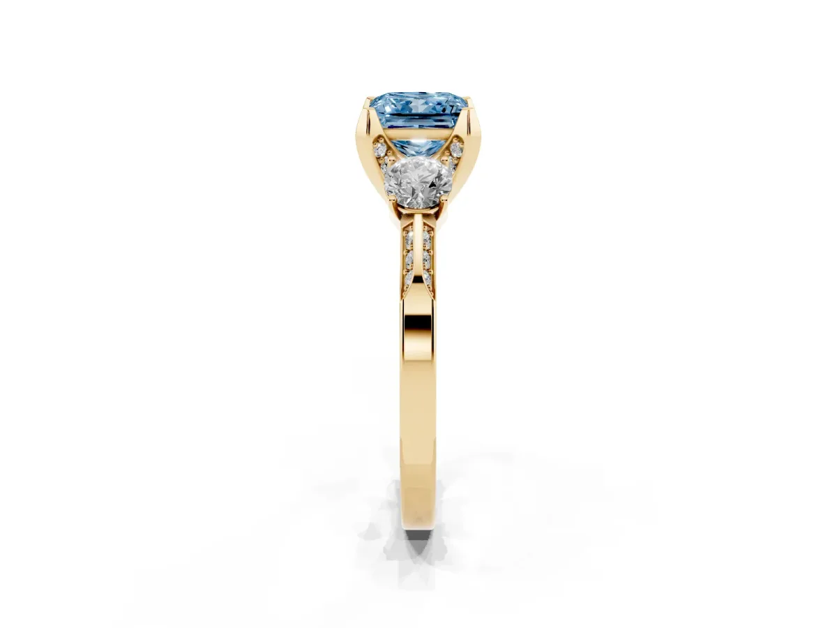 Fancy Blue Princess Cut Brilliant Three-Stone Diamond Ring with Pavé Band and Four-Prong Setting Yellow gold