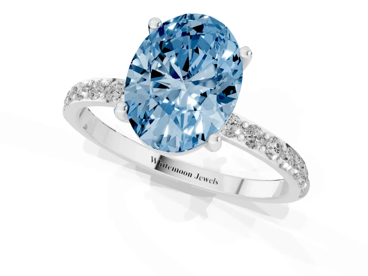 Fancy Blue Oval Cut Diamond Solitaire Ring with Round Pavé Shoulders and Prong Setting Silver