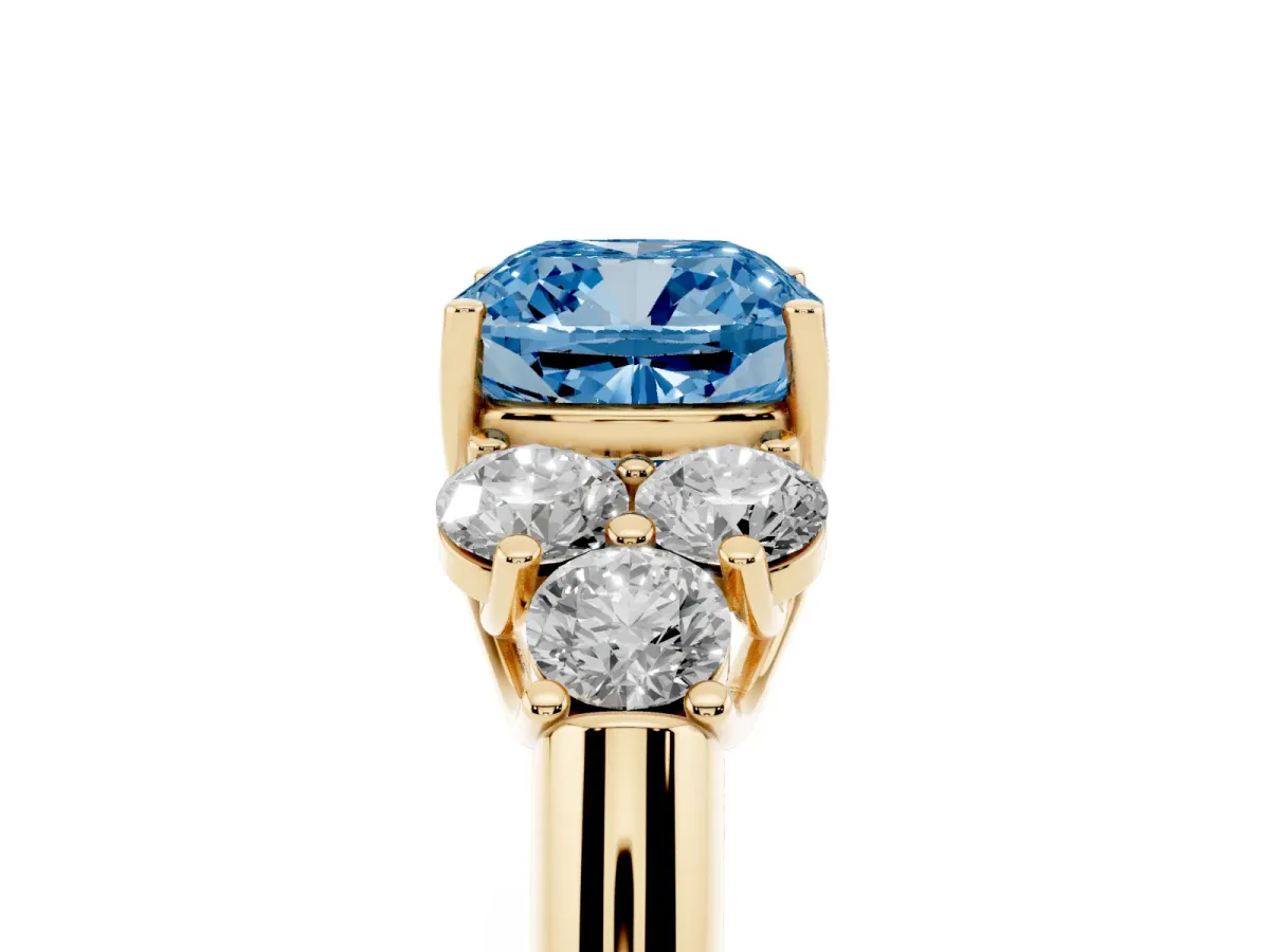 Fancy Blue Cushion Cut Cut Diamond Cluster Ring with Round Accent Stones and Prong Setting on a Classic Band Yellow gold