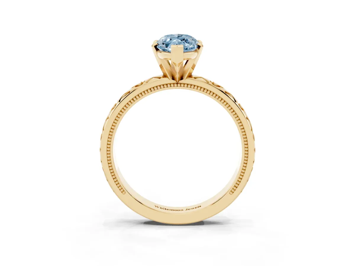 Fancy Blue Marquise Cut Solitaire Diamond Engagement Ring with XO Engraved Band and Four-Prong Setting Yellow gold