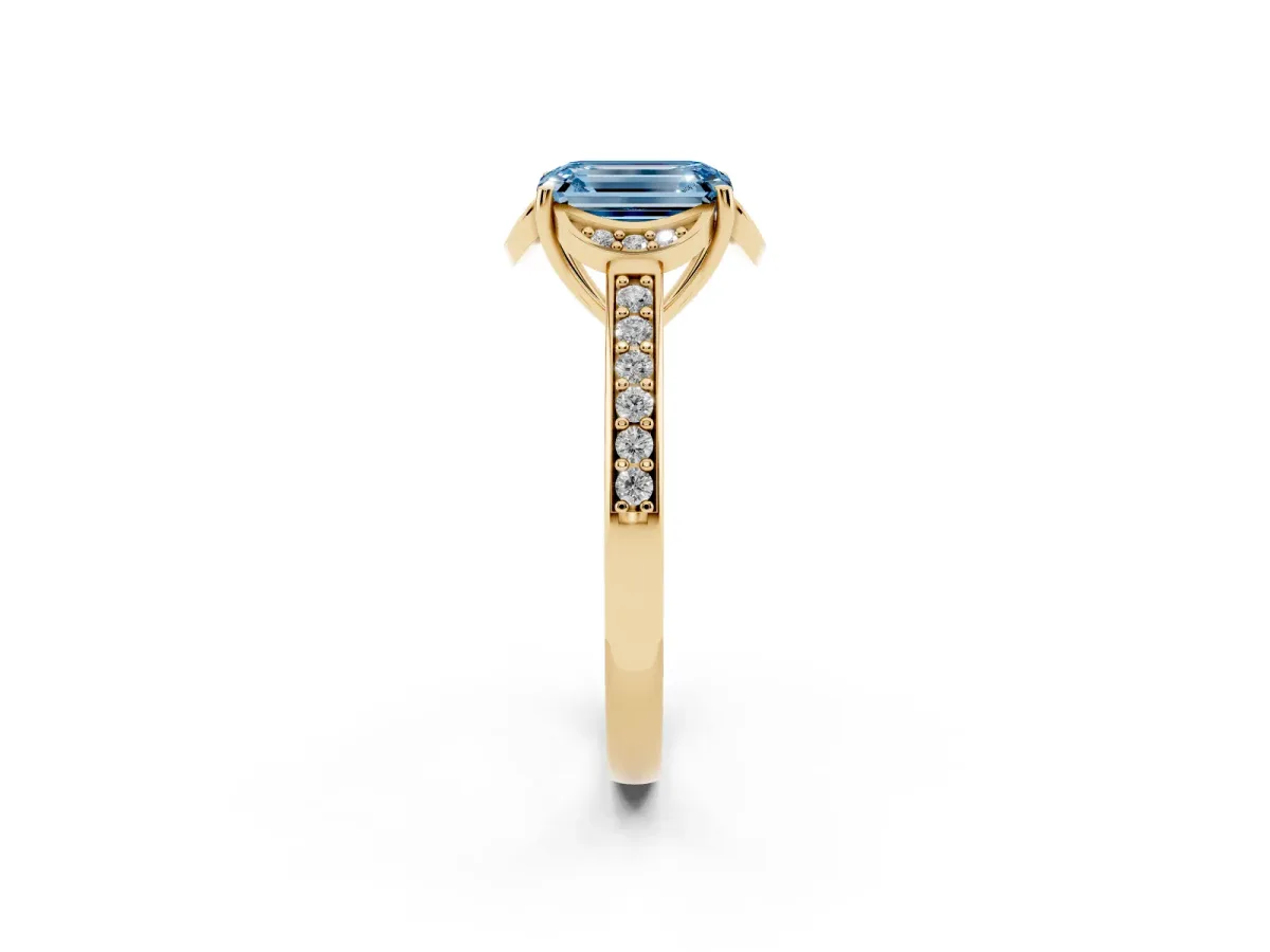 Fancy Blue Emerald Cut Cut Halo Diamond Ring with Channel Set Band and Four-Prong Setting Yellow gold