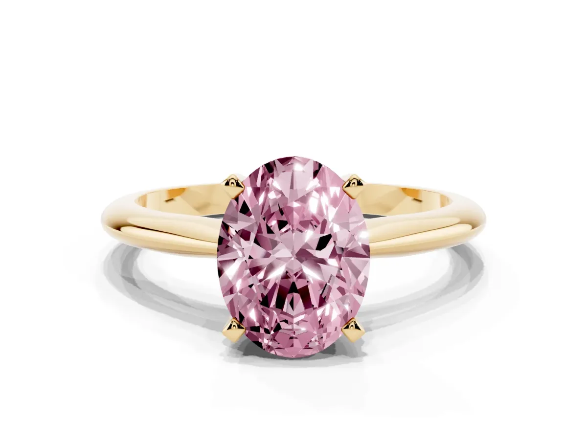 Fancy Pink Oval Cut Cut Solitaire Ring with Four-Prong Setting on a Classic Band Yellow gold