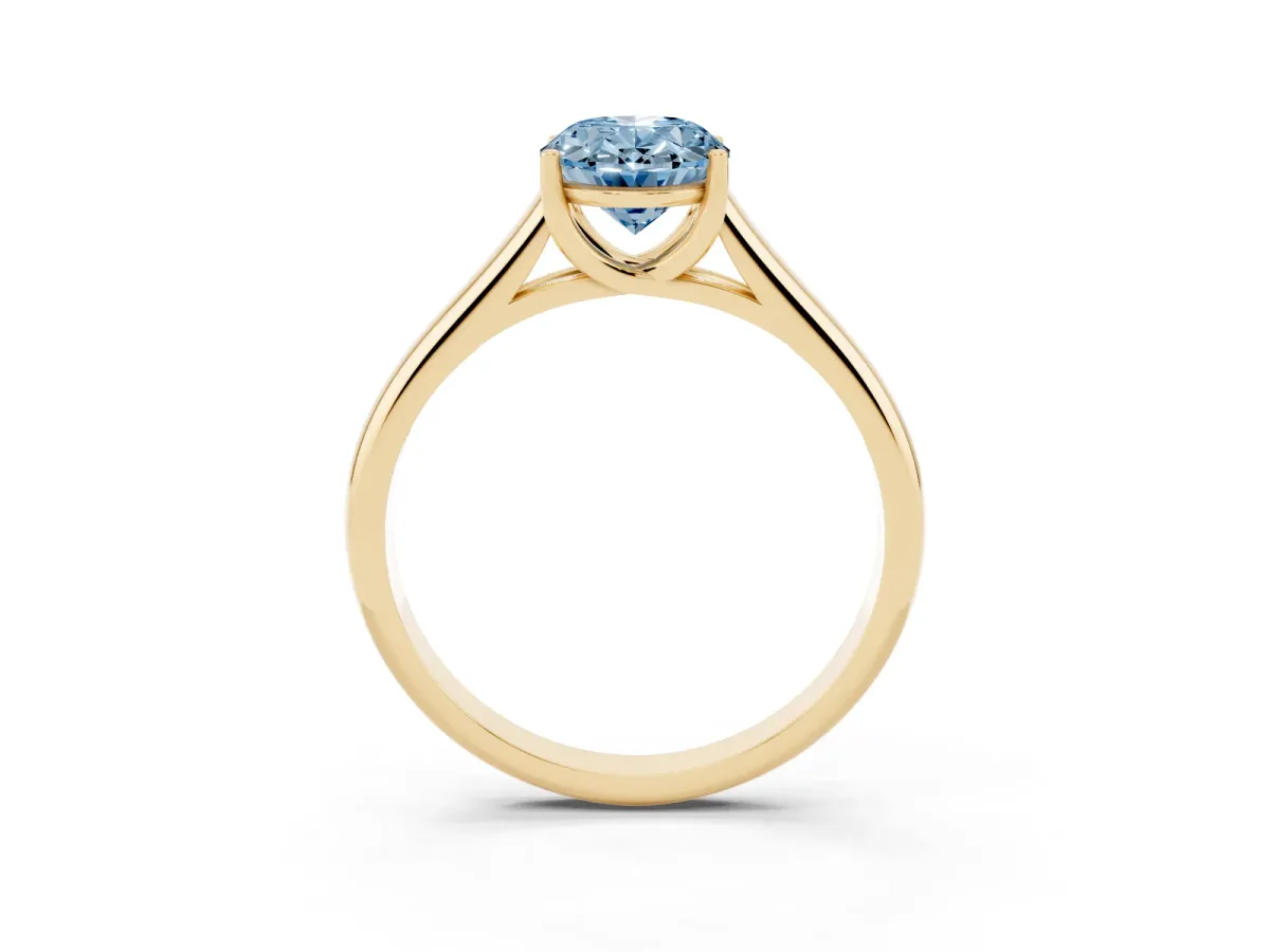 Fancy Blue Oval Cut Solitaire Engagement Ring with Tapered Band and Four-Prong Setting Yellow gold
