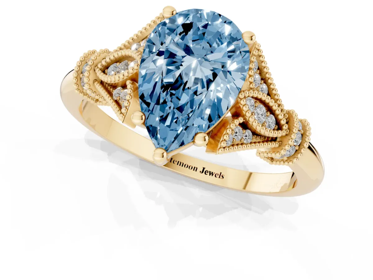 Fancy Blue Pear Cut Diamond Solitaire Ring with Floral Filigree and Pave Accents Yellow gold