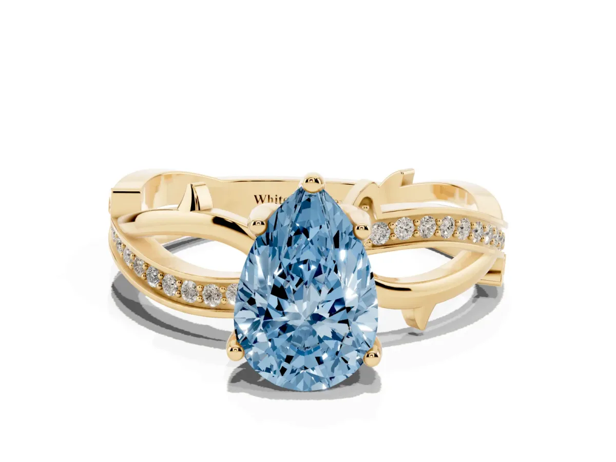 Fancy Blue Pear Cut Solitaire Twist Band with Pavé Accents and Four-Prong Setting Yellow gold