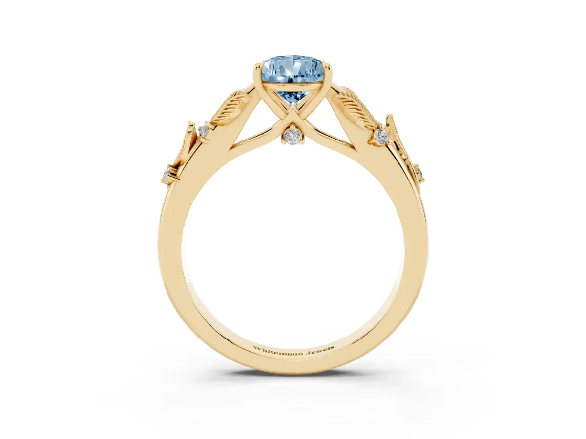 Fancy Blue Pear Cut Diamond Solitaire Ring with Leaf Motif Band and Four-Prong Setting Yellow gold
