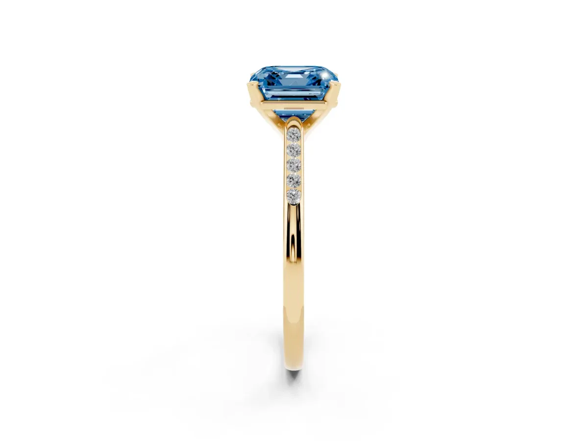 Fancy Blue Asscher Cut Diamond Solitaire Ring with Channel Set Round Band and Prong Setting Yellow gold