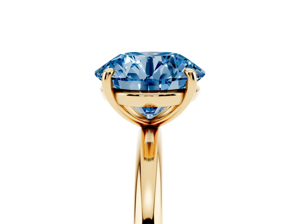 Fancy Blue Round Cut Solitaire Diamond Ring with Four-Prong Setting on a Plain Band Yellow gold