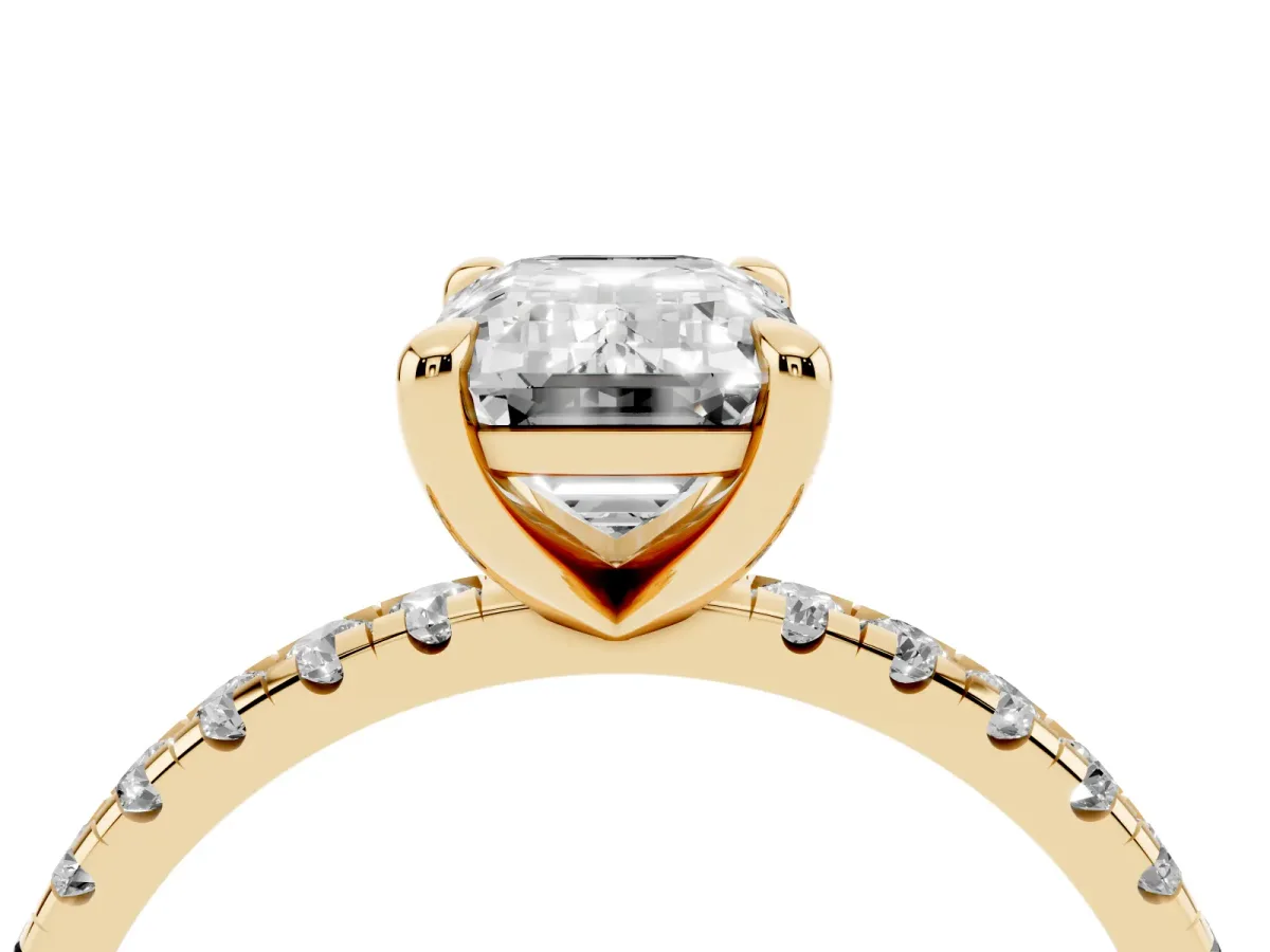 Emerald Cut Diamond Brilliant Solitaire Ring with Pavé Band and Four-Prong Setting Yellow gold
