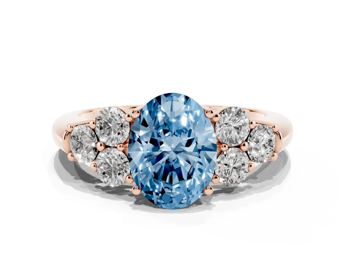 Fancy Blue Oval Cut Cut Diamond Cluster Ring with Round Accent Stones and Prong Setting on a Classic Band Rose gold