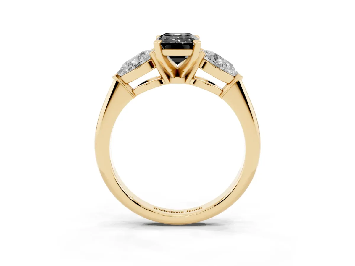Fancy Black Three-Stone Emerald Cut Diamond Ring with Pear Side Stones and Four-Prong Setting Yellow gold