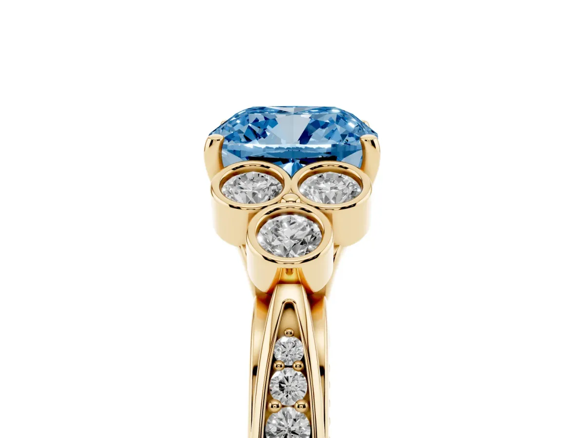 Fancy Blue Cushion Cut Cut Diamond Engagement Ring with Bezel Set Round Side Stones and Prong Setting Yellow gold